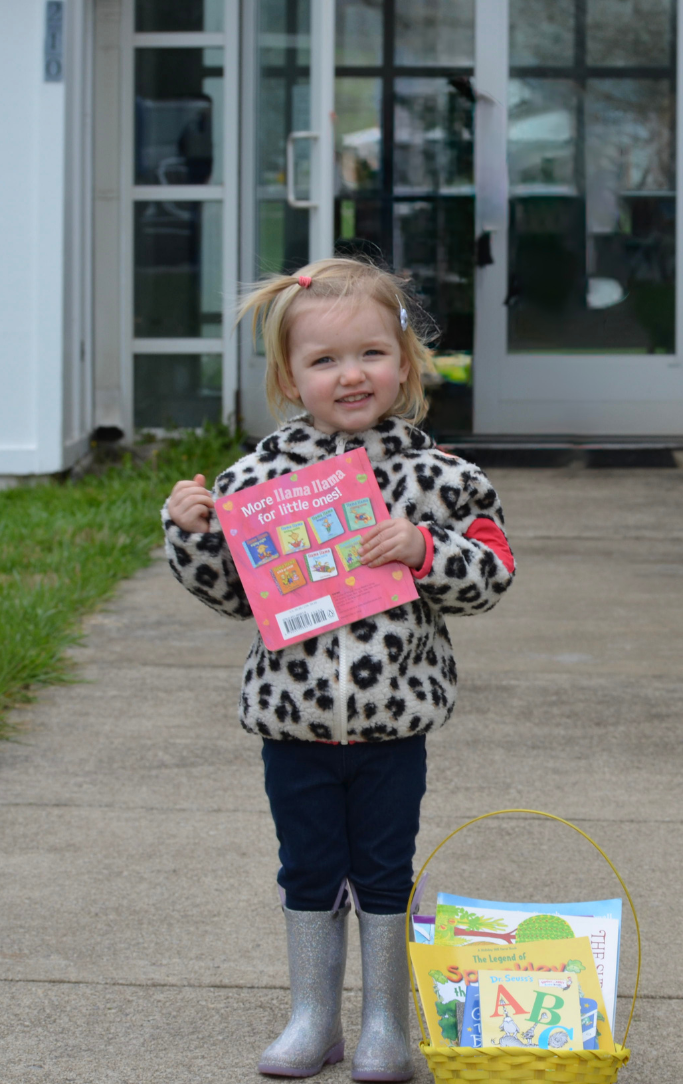 Olive holding a book at the racine library egg hunt