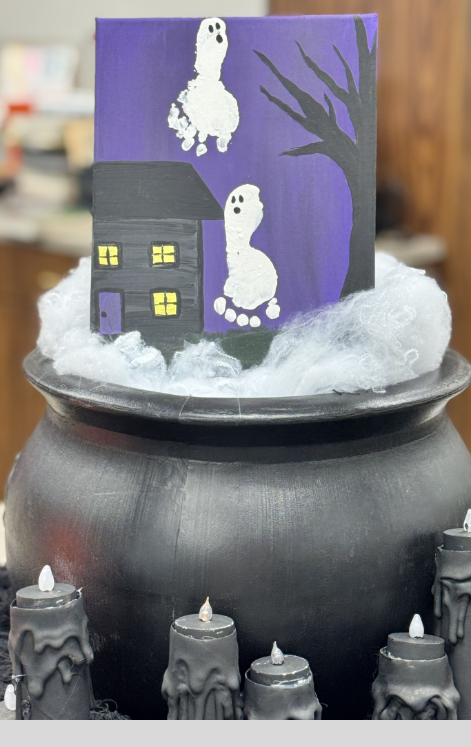 canvas painting of ghosts made from baby feet